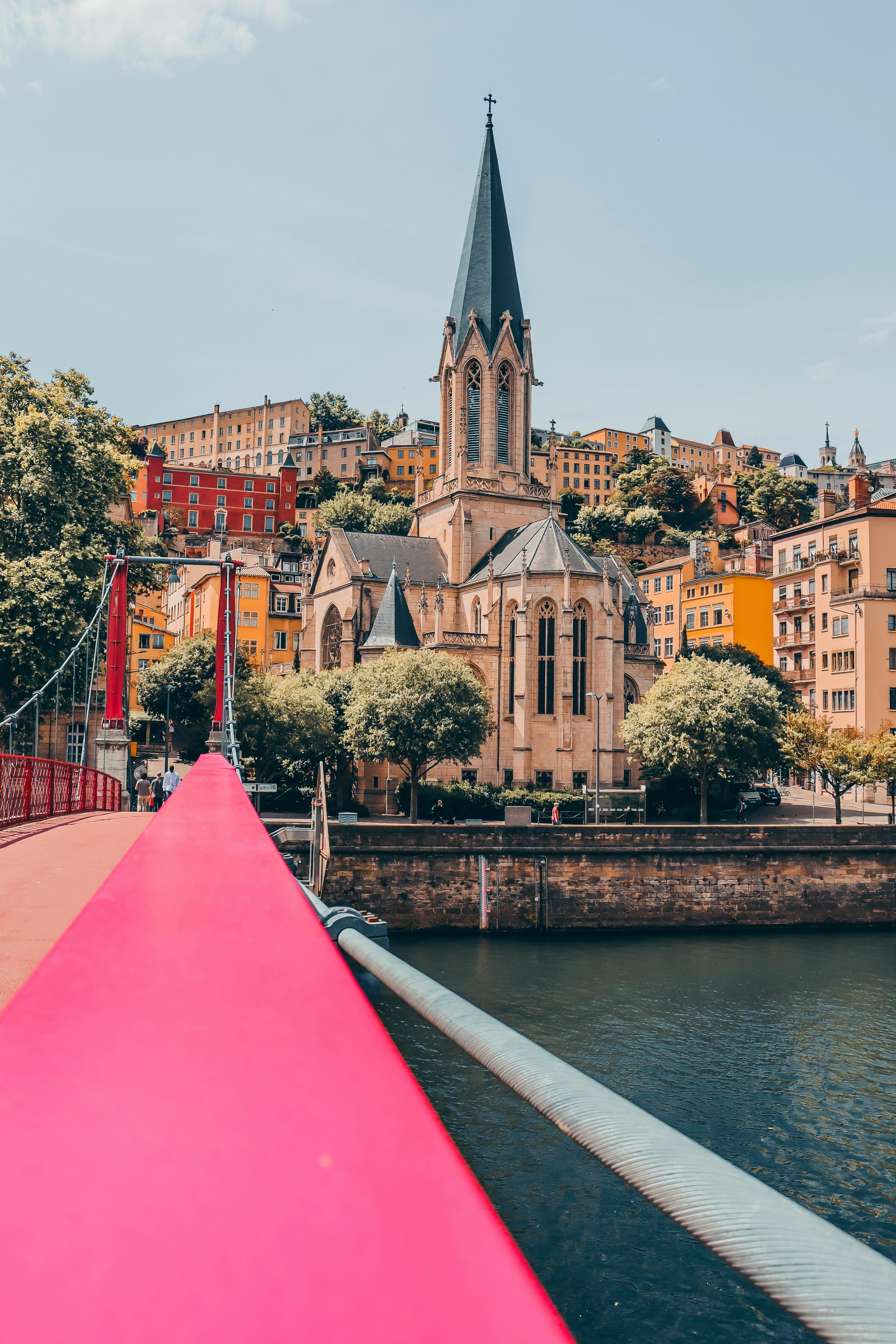 Panoramic view of Lyon, showcasing the Rhône and Saône rivers, historic architecture in the Old Town, and the iconic Basilica of Notre-Dame de Fourvière perched on a hill